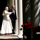 Pope Benedict XVI gives a hand signal to hidden operatives after infiltrating White House security to meet with President George W. Bush.
